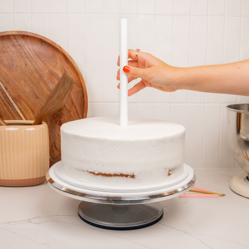 Placing a LOYAL Bakeware Heavy Duty Dowel into a cake for stacking